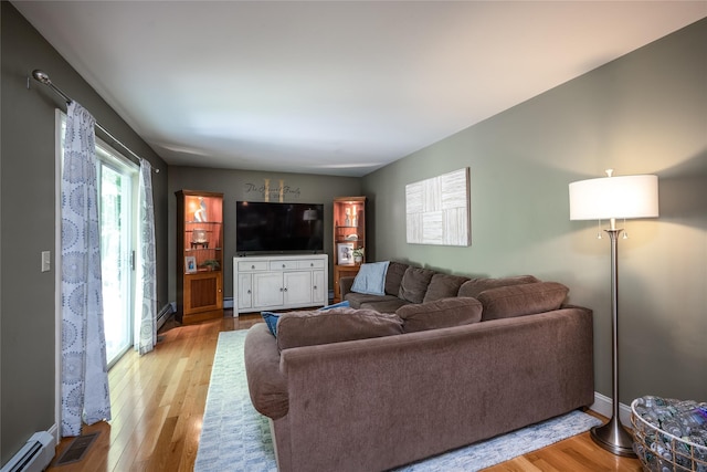 48 Devon Rd, Patterson, NY 12563 - living room featuring light wood finished floors and a baseboard heating unit