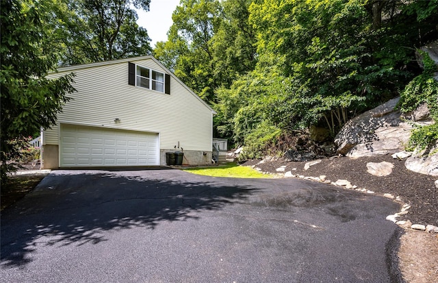 48 Devon Rd, Patterson, NY 12563 - view of property exterior featuring asphalt driveway and an attached garage