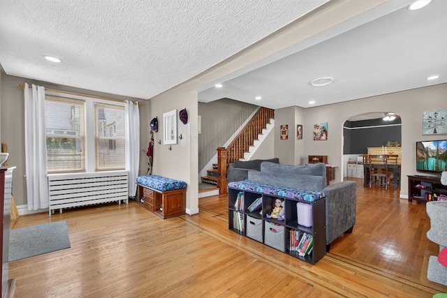 829 Logan Ave, Bronx, NY 10465 - dining space with arched walkways, stairs, hardwood / wood-style flooring, a textured ceiling, and recessed lighting