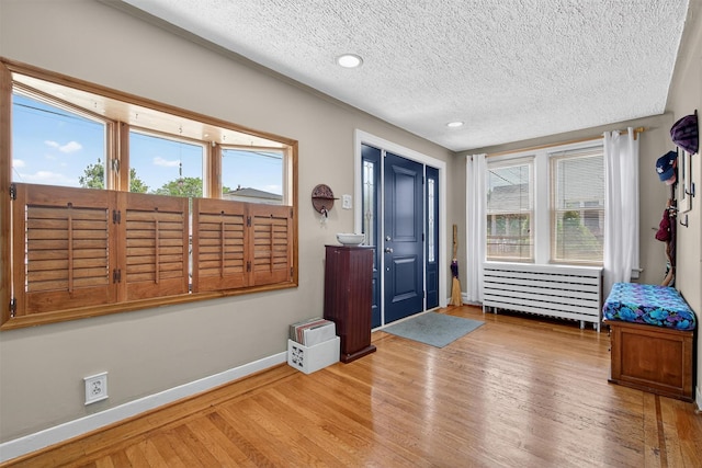 829 Logan Ave, Bronx, NY 10465 - foyer entrance with wood finished floors, a textured ceiling, and recessed lighting