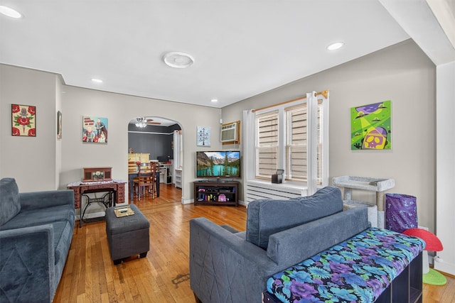 829 Logan Ave, Bronx, NY 10465 - living room with arched walkways, hardwood / wood-style flooring, a wall mounted air conditioner, recessed lighting, and ceiling fan