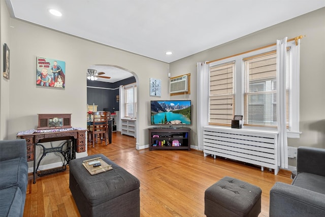 829 Logan Ave, Bronx, NY 10465 - living area with arched walkways, hardwood / wood-style floors, an AC wall unit, a ceiling fan, and recessed lighting