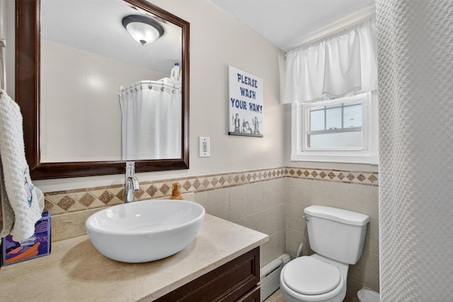 829 Logan Ave, Bronx, NY 10465 - bathroom with a baseboard heating unit, tile walls, vanity, and wainscoting