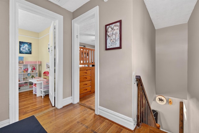 829 Logan Ave, Bronx, NY 10465 - corridor featuring an upstairs landing and light wood-style floors