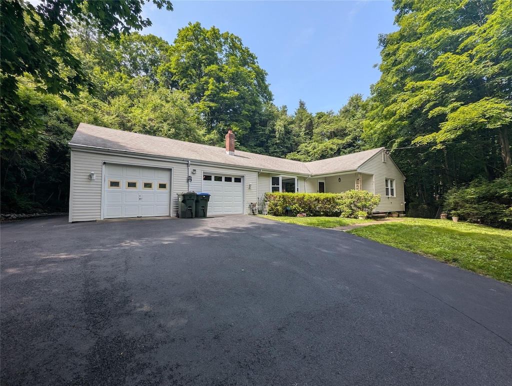 6 Oak Pl, Tuxedo Park, NY 10987 - single story home with asphalt driveway, an attached garage, a chimney, and a front lawn