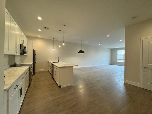 30 Beekman St Unit Ph3, Beacon, NY 12508 - kitchen featuring appliances with stainless steel finishes, recessed lighting, white cabinetry, dark wood finished floors, and light stone countertops