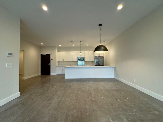 30 Beekman St Unit Ph3, Beacon, NY 12508 - kitchen with stainless steel appliances, white cabinets, open floor plan, recessed lighting, and decorative light fixtures