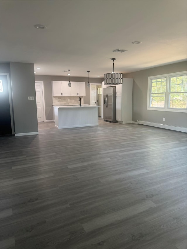 882 Union Blvd, West Islip, NY 11795 - unfurnished living room with dark wood finished floors, recessed lighting, and a baseboard radiator