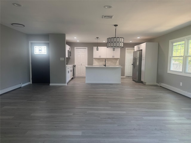 882 Union Blvd, West Islip, NY 11795 - kitchen with stainless steel appliances, dark wood finished floors, baseboard heating, open floor plan, and recessed lighting