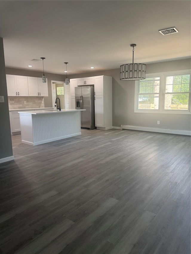 882 Union Blvd, West Islip, NY 11795 - kitchen with stainless steel fridge, recessed lighting, white cabinets, dark wood-style floors, and open floor plan