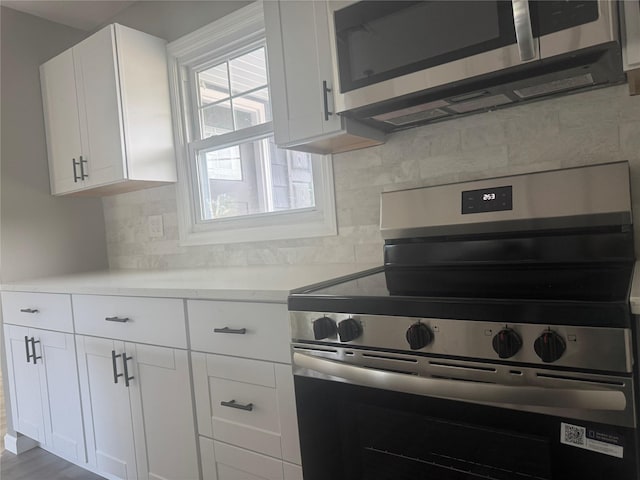 882 Union Blvd, West Islip, NY 11795 - kitchen featuring appliances with stainless steel finishes, light countertops, and backsplash