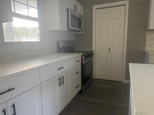 882 Union Blvd, West Islip, NY 11795 - kitchen with appliances with stainless steel finishes, dark wood-style floors, and white cabinetry