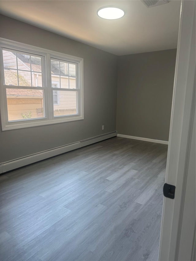 882 Union Blvd, West Islip, NY 11795 - unfurnished room with baseboard heating and wood finished floors