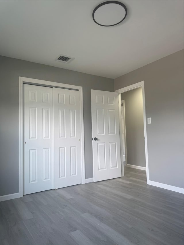 882 Union Blvd, West Islip, NY 11795 - unfurnished bedroom with wood finished floors and a closet