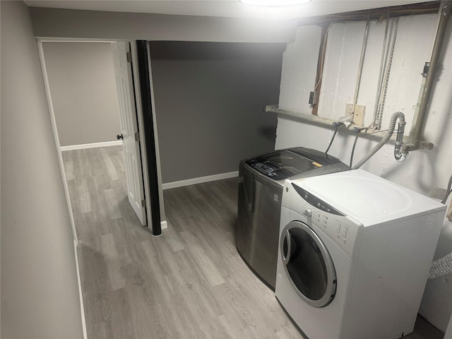 882 Union Blvd, West Islip, NY 11795 - laundry area with washing machine and dryer and light wood-style floors