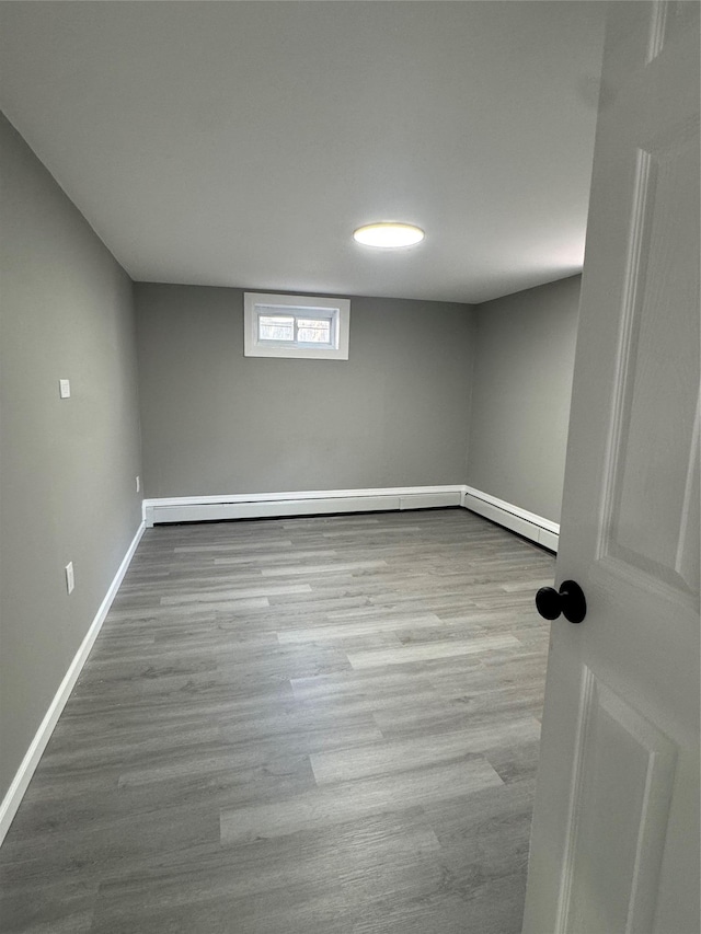 882 Union Blvd, West Islip, NY 11795 - empty room with baseboard heating and wood finished floors
