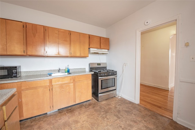 4037 77th St Unit 5B, Elmhurst, NY 11373 - kitchen with stainless steel gas stove, black microwave, under cabinet range hood, and light countertops