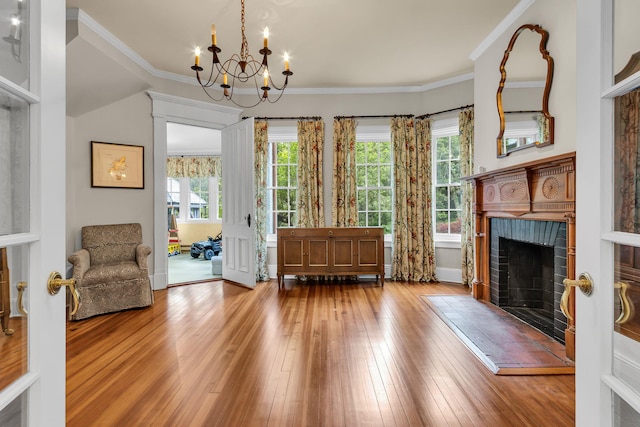 77 Haights Cross Rd, Chappaqua, NY 10514 - living area with hardwood / wood-style flooring, a fireplace, a chandelier, and ornamental molding