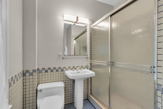 77 Haights Cross Rd, Chappaqua, NY 10514 - full bath with tile walls, a shower stall, a wainscoted wall, and tile patterned flooring