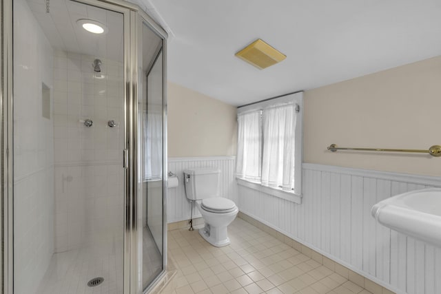 77 Haights Cross Rd, Chappaqua, NY 10514 - bathroom with wainscoting, a stall shower, and tile patterned floors