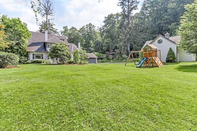 77 Haights Cross Rd, Chappaqua, NY 10514 - view of green lawn featuring a playground and a garage