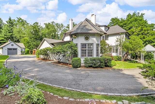 77 Haights Cross Rd, Chappaqua, NY 10514 - view of front of property featuring an outdoor structure, a detached garage, and a chimney