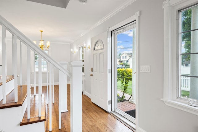 1859 George Ct, Merrick, NY 11566 - entrance foyer with a chandelier, light wood-style floors, stairway, and ornamental molding