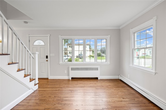 1859 George Ct, Merrick, NY 11566 - foyer featuring radiator heating unit, a baseboard radiator, healthy amount of natural light, wood finished floors, and ornamental molding