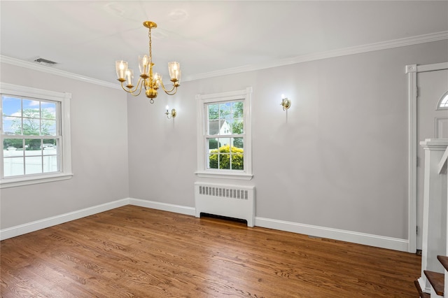 1859 George Ct, Merrick, NY 11566 - spare room with radiator heating unit, a chandelier, ornamental molding, and wood finished floors