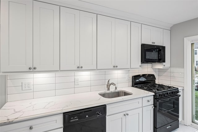 1859 George Ct, Merrick, NY 11566 - kitchen with black appliances, light stone counters, white cabinets, and backsplash