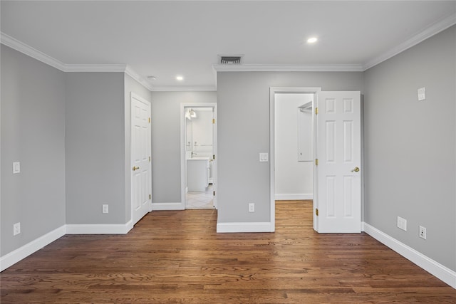 1859 George Ct, Merrick, NY 11566 - unfurnished bedroom featuring a spacious closet, ornamental molding, recessed lighting, wood finished floors, and ensuite bath