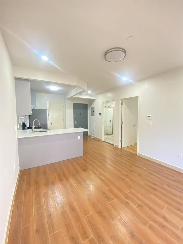 42-22 Crescent St Unit 3B, Long Island City, NY 11101 - unfurnished living room with light wood-style floors and baseboards