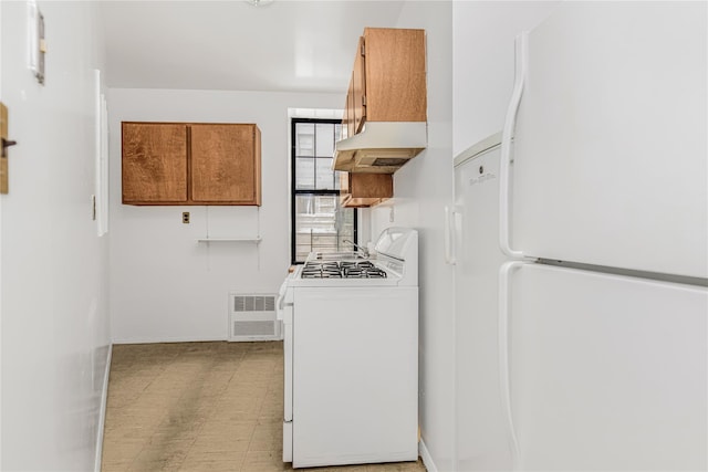 33 Convent Ave Unit 9, New York Manhattan, NY 10027 - kitchen with white appliances, premium range hood, brown cabinets, and light floors
