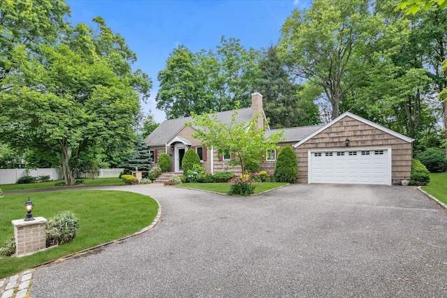 1 Willits Rd, Glen Cove, NY 11542 - view of front of house with asphalt driveway, a chimney, and an attached garage