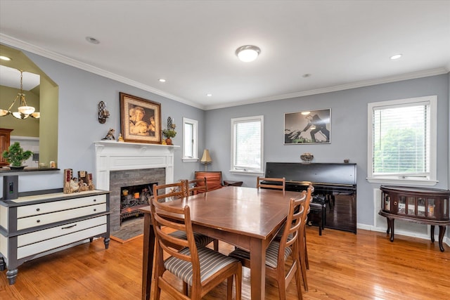 1 Willits Rd, Glen Cove, NY 11542 - dining area with light wood-style floors, a fireplace, healthy amount of natural light, crown molding, and recessed lighting