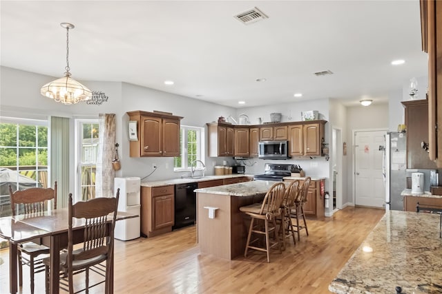 9 Clark Rd, Goshen, NY 10924 - kitchen featuring stainless steel appliances, a kitchen island, a kitchen breakfast bar, light wood-style floors, and recessed lighting