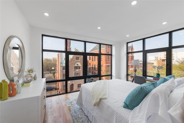 926 Herkimer St, Brooklyn, NY 11233 - bedroom featuring a wall of windows, light wood-style floors, and recessed lighting