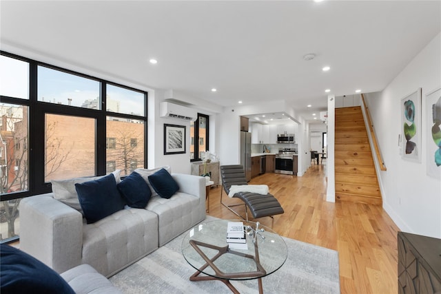 926 Herkimer St, Brooklyn, NY 11233 - living room featuring a wall unit AC, stairway, light wood-type flooring, and recessed lighting