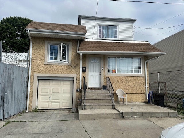 9015 Krier Pl, Brooklyn, NY 11236 - view of front facade with an attached garage, roof with shingles, driveway, and stucco siding