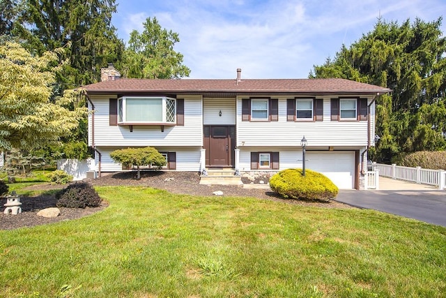 7 Gilmore Dr, Stony Point, NY 10980 - raised ranch with a garage, asphalt driveway, entry steps, and a chimney