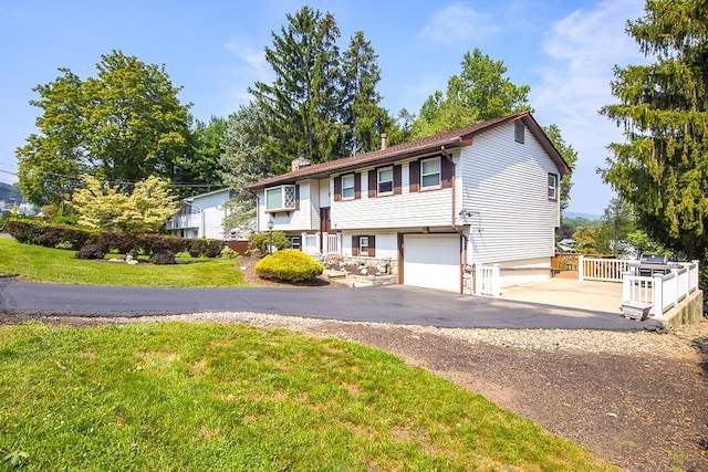 7 Gilmore Dr, Stony Point, NY 10980 - view of front of house featuring driveway, a front yard, an attached garage, and a chimney