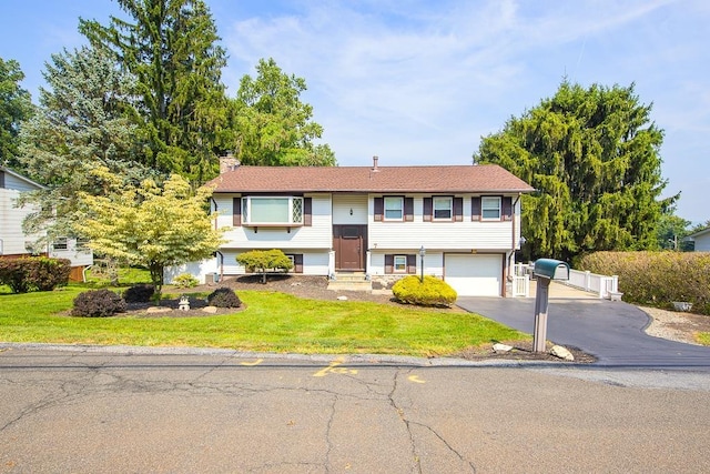 7 Gilmore Dr, Stony Point, NY 10980 - bi-level home featuring an attached garage, driveway, a chimney, and a front yard