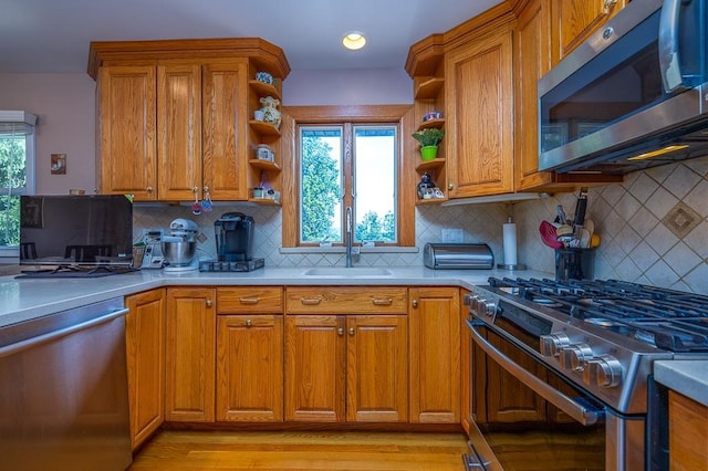7 Gilmore Dr, Stony Point, NY 10980 - kitchen with stainless steel appliances, open shelves, brown cabinetry, and light countertops