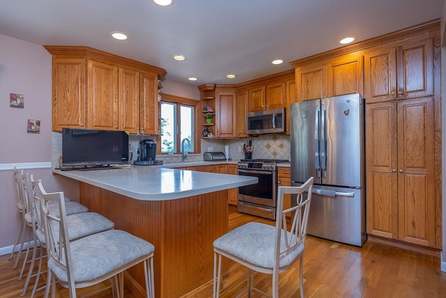 7 Gilmore Dr, Stony Point, NY 10980 - kitchen with stainless steel appliances, a peninsula, brown cabinets, open shelves, and recessed lighting