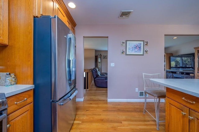 7 Gilmore Dr, Stony Point, NY 10980 - kitchen featuring freestanding refrigerator, light wood-style flooring, brown cabinetry, and light countertops