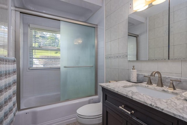 7 Gilmore Dr, Stony Point, NY 10980 - bathroom with vanity, tile walls, and combined bath / shower with glass door