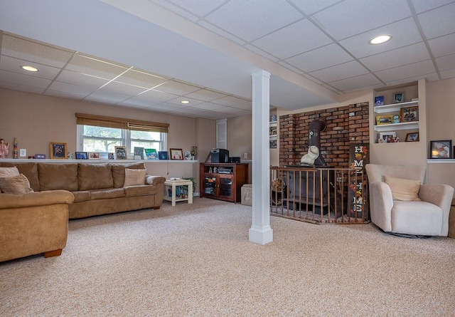 7 Gilmore Dr, Stony Point, NY 10980 - carpeted living room with a drop ceiling, a wood stove, ornate columns, and recessed lighting