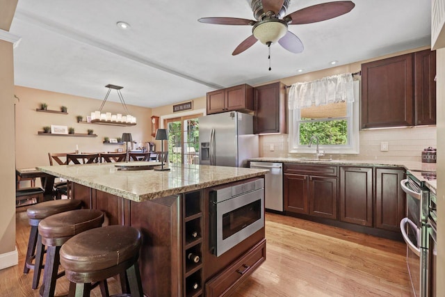 39 Bykenhulle Rd, Hopewell Junction, NY 12533 - kitchen featuring appliances with stainless steel finishes, a kitchen bar, decorative backsplash, and plenty of natural light
