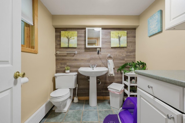 39 Bykenhulle Rd, Hopewell Junction, NY 12533 - bathroom with wood walls, a baseboard radiator, and tile patterned floors