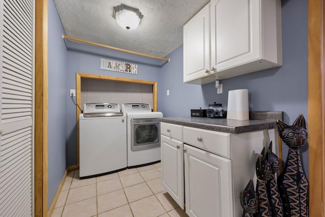 39 Bykenhulle Rd, Hopewell Junction, NY 12533 - laundry area with separate washer and dryer, a textured ceiling, cabinet space, and light tile patterned flooring